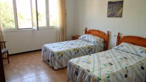 Ένα ή περισσότερα κρεβάτια σε δωμάτιο στο Casa Carmelo Casa amplia con jardín