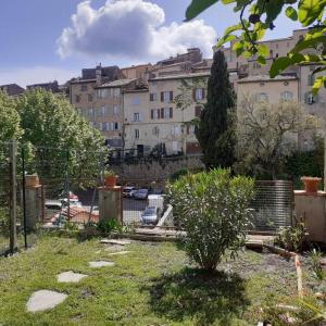 a garden in front of a large building at Maison dans un village du Var avec jardin in Seillans