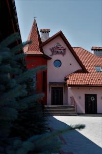 a house with a christmas tree in front of it at УЗВАР in Bobrka