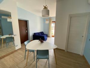 a living room with a white table and chairs at B&B Syrentum in Sorrento