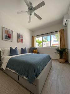 Schlafzimmer mit einem Bett und einem Deckenventilator in der Unterkunft Casa Mulata Coral Village Pool & Playa 2 in Punta Cana