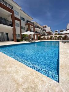 a swimming pool in front of a building at Casa Mulata Coral Village Pool & Playa 2 in Punta Cana