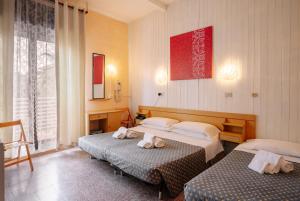 Postel nebo postele na pokoji v ubytování Hotel Aurora