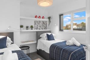 a bedroom with two beds and a window at Contractor Accommodation 4 Bedroom House Sleeps 7 Free Van Parking Near Avonmouth Docks in Avonmouth