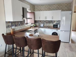 a kitchen with a table and some white cabinets at Apartamento Real 17, Cádiar in Cádiar