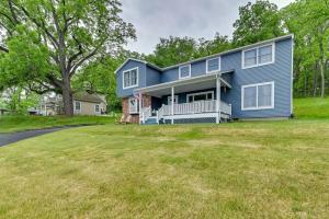 a blue house with a large yard at Spacious Canandaigua Lake House with Dock and Kayak! in Canandaigua