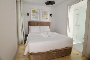 a bedroom with a large bed with two towels on it at Trindade Apartments by PHC in Porto