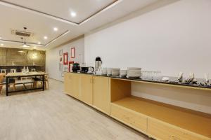 a kitchen with a counter with plates on it at Super townhouse moosapet Rcc Prime in Hyderabad