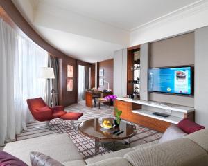 a living room with a couch and a tv at One World Hotel in Petaling Jaya