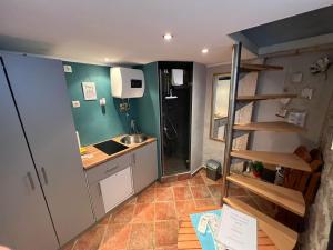 a small kitchen with a sink and a refrigerator at Aurora Tiny Apartment in Zadar