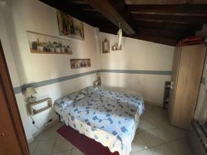 a small bedroom with a bed in a room at Independent Little Loft in Modena in Modena