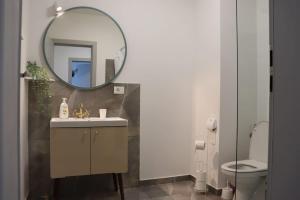 a bathroom with a sink and a mirror at Apart Relax Baile Felix in Cordău