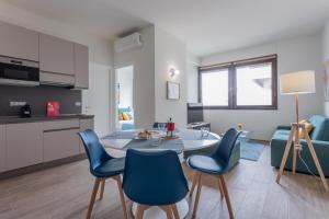 a kitchen and living room with a table and chairs at Garden Palace by Wonderful Italy - Apartment in Turin