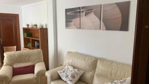 a living room with a couch and a chair at Nice Home+Wifi+AC+Netflix in Valladolid