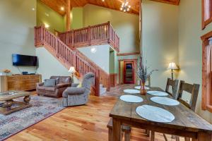 a living room with a wooden table and stairs at Slaty Fork Home about 6 Mi to Snowshoe Mountain Resort in Slaty Fork