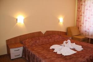 A bed or beds in a room at Hotel Golden fish Nessebur