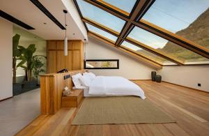 a bedroom with a bed in a room with windows at ANNICA Villa in Zhangjiajie