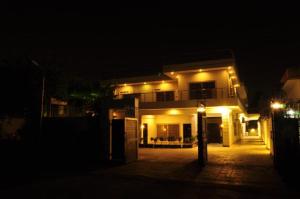 a house lit up at night with lights on it at Reina Boutique Hotel - G6 in Islamabad