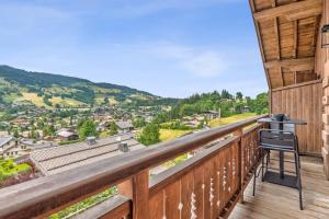 a view from the balcony of a house with a camera at Studio Belvédère - Welkeys in Megève