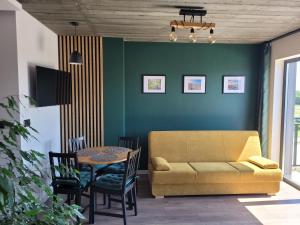 a living room with a couch and a table at Loft 66 Apartamenty in Władysławowo