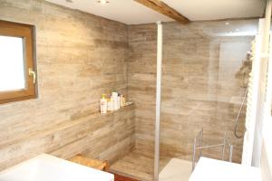 a bathroom with a shower and two sinks at LA CHAUMIERE DE TAVOU in Cornimont +10 photos