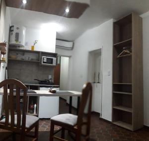 a kitchen with a table and chairs in a room at Departamentos Junin in San Fernando del Valle de Catamarca +4 photos
