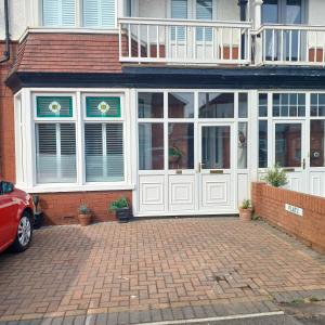 a house with white doors and a brick driveway at Lovely 2-Bed Apartment in Bridlington in Bridlington