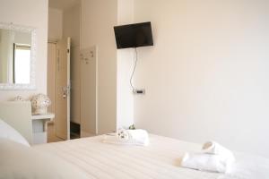 Postel nebo postele na pokoji v ubytování Hotel Sirena - Servizio spiaggia inclusive