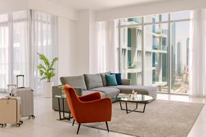 a living room with a couch and a table at Sonder Downtown Towers in Dubai