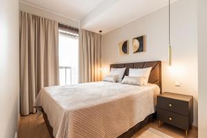 a bedroom with a large bed and a window at Laulupargi Lux Residence in Tallinn