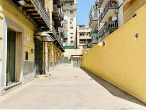 an empty alley in a city with buildings at Palermo Central in Palermo