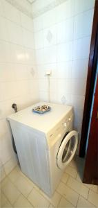 a washing machine with a plate on top of it in a bathroom at Perivolia Serenity in Chania in Ayiá