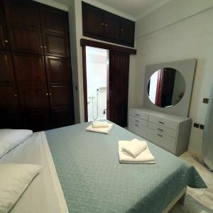 a bedroom with a bed with two towels on it at Perivolia Serenity in Chania in Ayiá