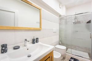 a bathroom with a sink and a toilet and a mirror at Il Truciolo in Castellaccia +39 photos