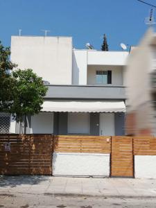 a building with a wooden fence in front of it at Family Inn in Athens