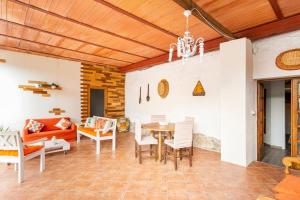 a dining room and living room with a table and chairs at Il Truciolo in Castellaccia