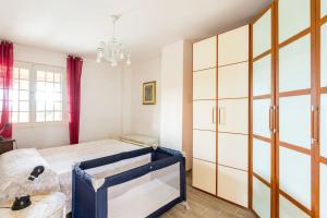 a bedroom with a large bed and a chandelier at Il Truciolo in Castellaccia