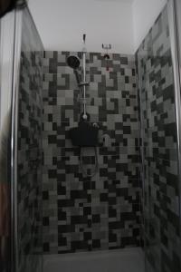a bathroom with a shower with a toilet at La Suite del Borgo in Bovalino Marina +9 photos