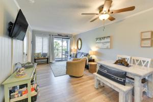 a living room with a table and a ceiling fan at Less Than 1 Mi to Beach Hilton Head Island Condo with Pool! in Hilton Head Island