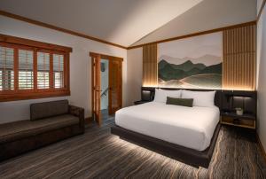 a bedroom with a bed and a chair and a couch at Nita Lake Lodge in Whistler