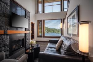 a living room with a couch and a fireplace at Nita Lake Lodge in Whistler