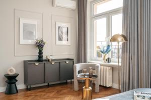 a living room with a cabinet and a table at Penthouse Panorama - LoftAffair in Kraków