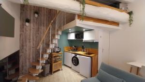 a small apartment with a staircase in a room at Studio cosy, quai de Saône, centre ville in Lyon