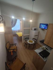 a small apartment with a living room with a table and chairs at New apartment BARNABA close to Holiday Inn in Tbilisi City