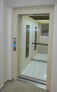 a glass door of a elevator in a building at Pela's Apartment for Filoxenia in Alexandroupoli
