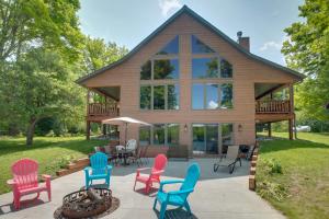 ein Haus mit bunten Stühlen davor in der Unterkunft Lakefront Cottage in Iron River with 2 Porches! in Iron River