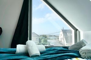 een slaapkamer met een raam met uitzicht op een straat bij L’Effet Mer*70m de la mer*Prise voiture électrique in Ploemeur