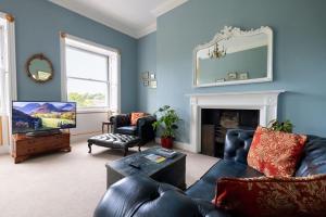 a living room with a couch and a fireplace at Crescent Green in Bath