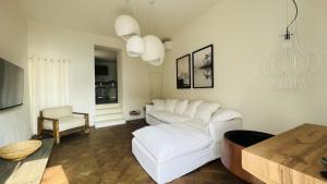 a living room with a white couch and a table at Gemma Lodge in Sulzano
