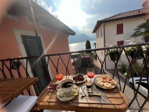 a table with food and drinks on a balcony at Gemma Lodge in Sulzano